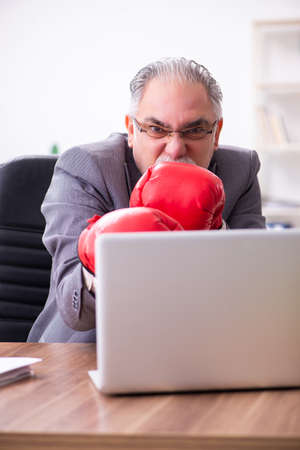 Businessman angry and furious at the workplaceの写真素材