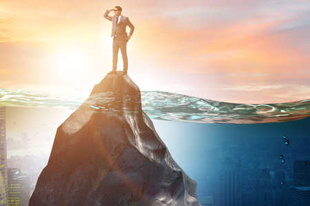 Businessman desperate on desert island in business conceptの写真素材