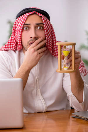 Young male arab employee working in the officeの写真素材