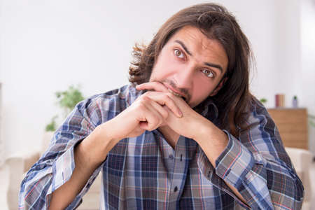 Young man suffering at home