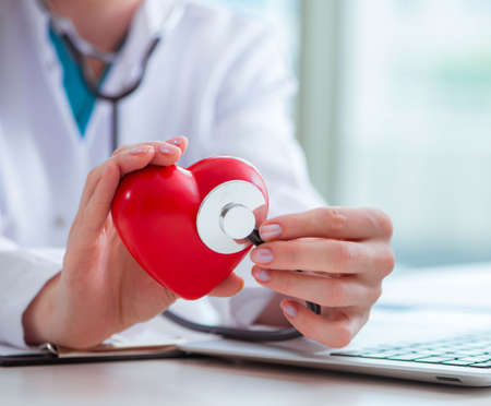 The doctor checking up heart in medical concept