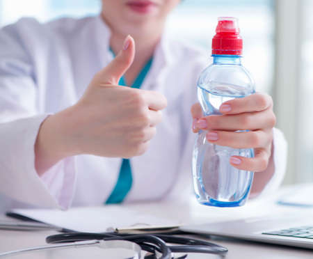 The doctor hand with fresh water in medical conceptの写真素材