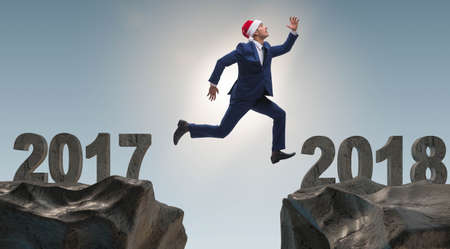 The businessman in santa hat jumping from 2017 to 2018の写真素材
