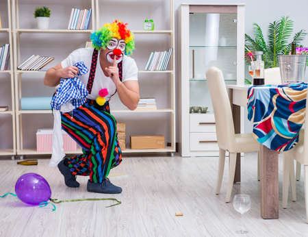 The drunk clown celebrating having a party at homeの写真素材