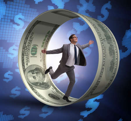 The businessman in hamster wheel chasing dollarsの写真素材