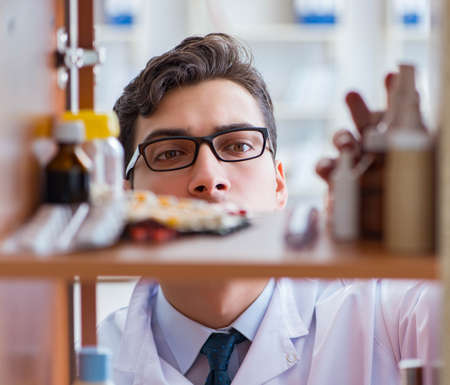 Doctor at farmacy retail shop looking for medicinesの写真素材