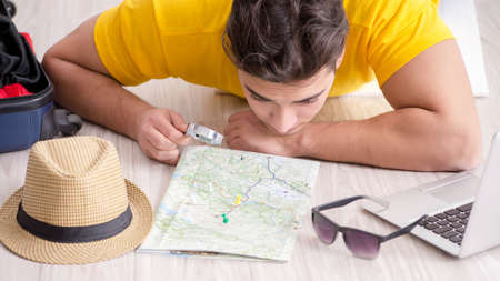 The man planning his vacation trip with map