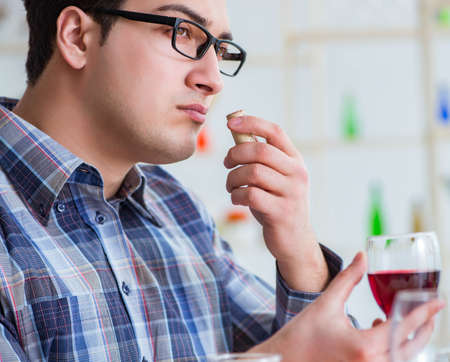 Professional sommelier tasting red wine