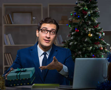 Businessman working late on christmas day in officeの写真素材