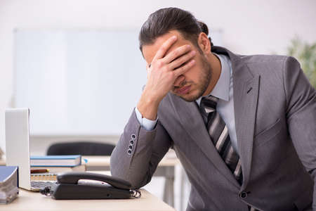Young male employee working in the officeの写真素材