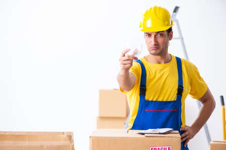 Young male professional mover doing home relocation