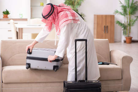 Old arab businessman preparing for business tripの写真素材