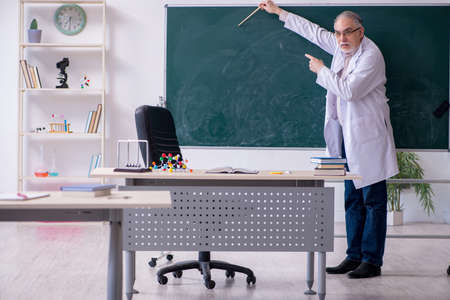 Experienced old scientist working in the lab