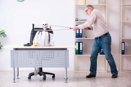 Old leg injured man visiting dead doctorの写真素材