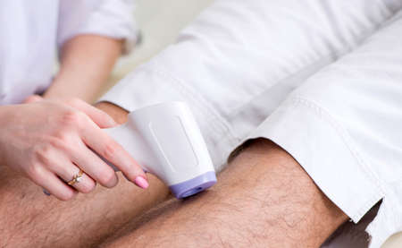 Young man visiting doctor for epilationの写真素材