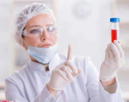 Woman doctor checking blood samples in labの写真素材