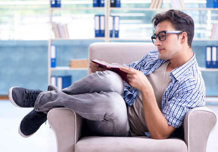 Student reading books and preparing for exams in libraryの写真素材