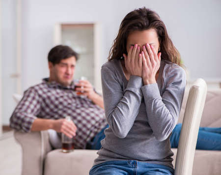 The drinking problem drunk husband man in a young family conceptの写真素材