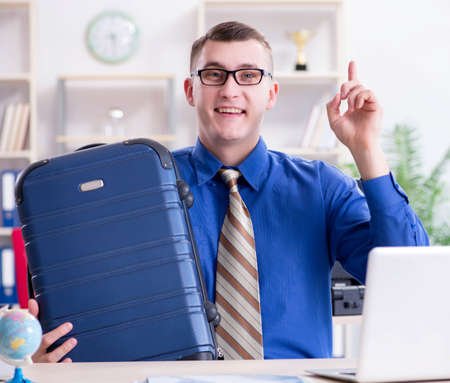 Young employee preparing for vacation tripの写真素材