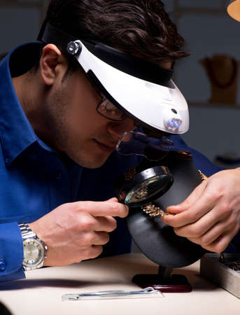 Jeweler working in his workshop late at night