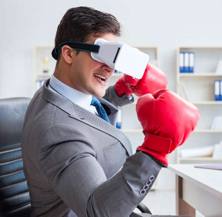 Man boxing in the office with virtual reality goggles