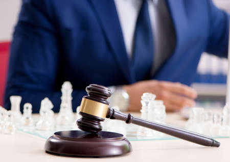 Young lawyer playing chess to train his court strategy and tactiの写真素材