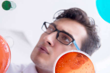 Chemist working in the laboratory with hazardous chemicals