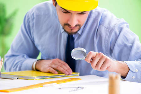 Young male architect working at the projectの写真素材