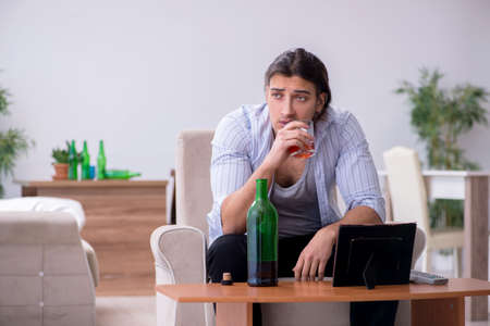 Young male alcoholic in unrequited love conceptの写真素材
