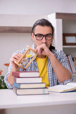 Young male student preparing for exam at homeの写真素材