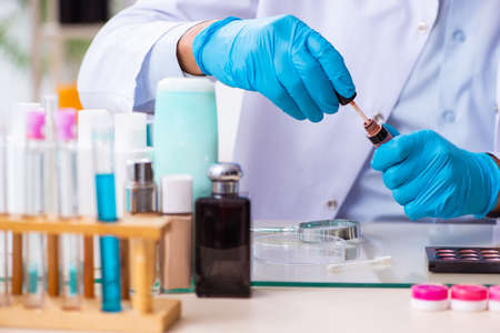 Young male chemist working in the lab