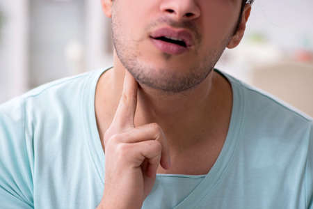 Young man suffering from sore throat