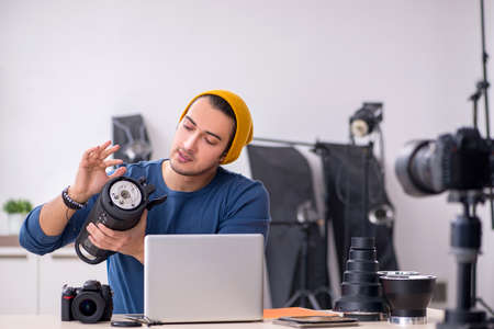 Young male photographer recording video for his blog