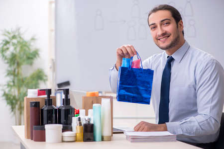 Young male shopaholic in e-commerce conceptの写真素材