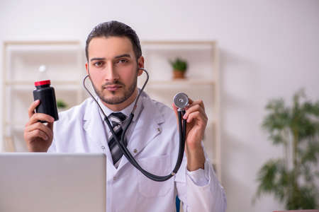 Young male doctor working in the clinicの写真素材