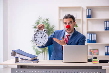 Funny employee clown working in the officeの写真素材