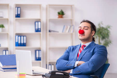 Funny employee clown working in the officeの写真素材