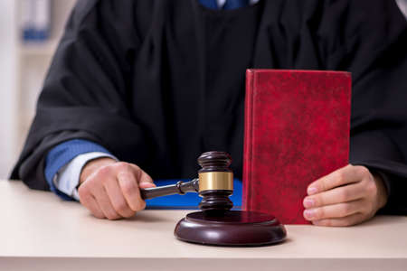 Young male judge working in courthouseの写真素材
