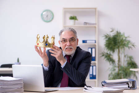 Old king businessman employee at workplaceの写真素材