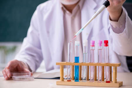 Experienced old scientist working in the lab