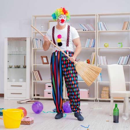 The funny clown doing cleaning at homeの写真素材