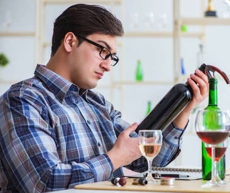 The professional sommelier tasting red wineの写真素材