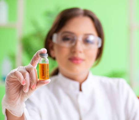 Beautiful female biotechnology scientist chemist working in lab