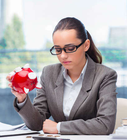 The bankrupt broke businesswoman with piggy bankの写真素材