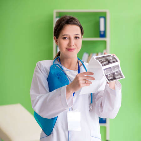 Female doctor gynecologyst writing medical record in the clinicの写真素材