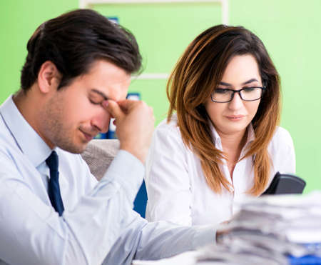 Two financial specialists working in the officeの写真素材