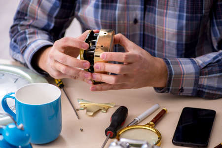 Young male watchmaker working in the workshopの写真素材