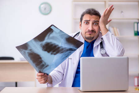 Young male doctor working in the clinic