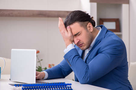 Young male employee working from the houseの写真素材