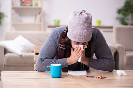 Young man suffering at homeの写真素材